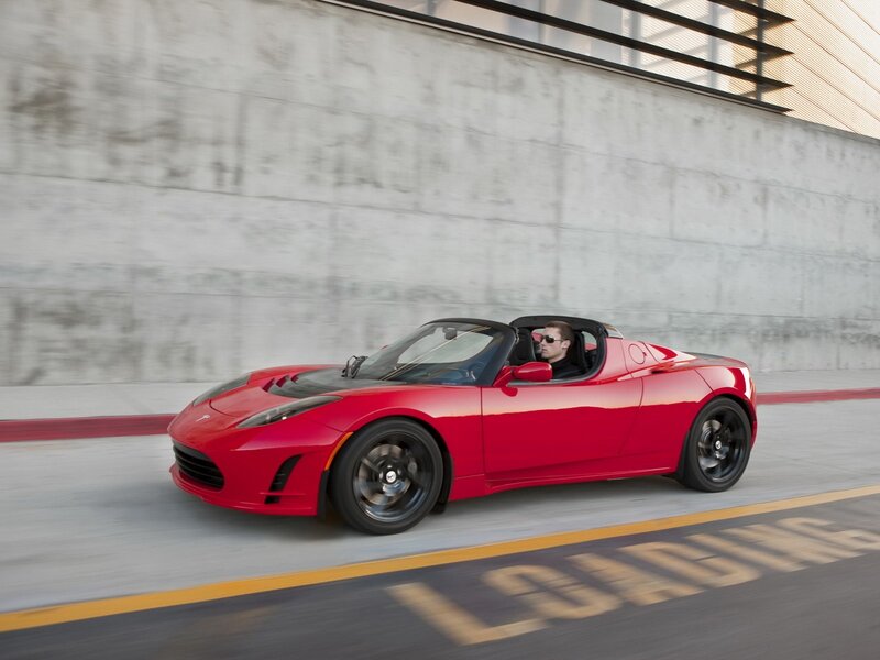 Red Tesla Roadster in motion