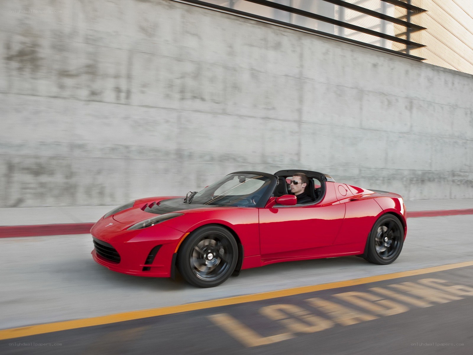 Red Tesla Roadster in motion