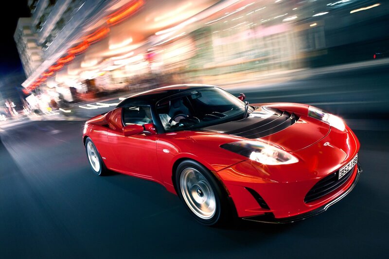 Red Tesla Roadster in motion