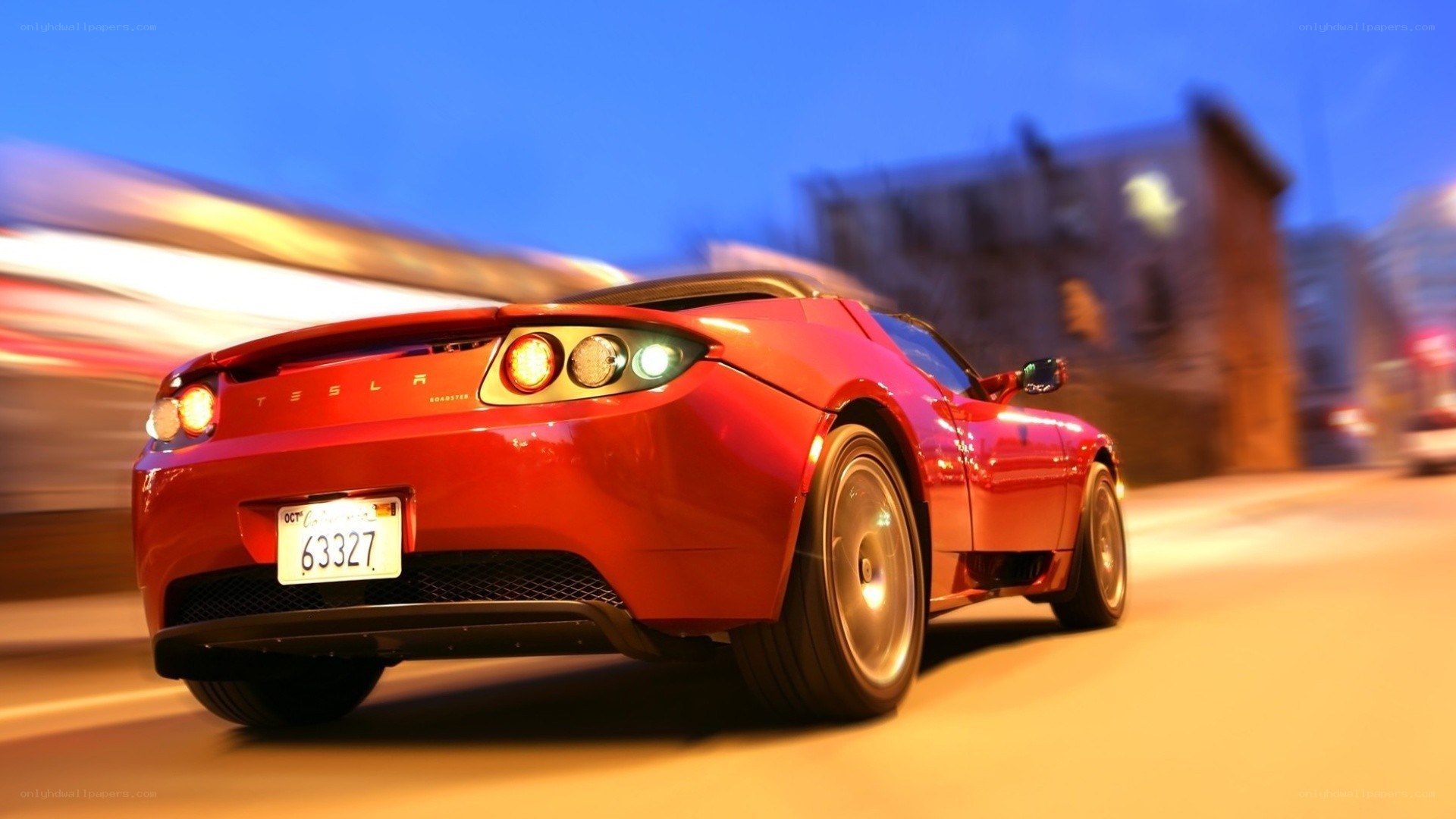 Red Tesla Roadster in motion