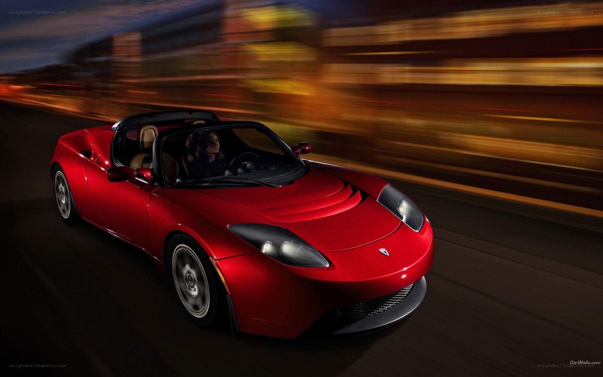 Red Tesla Roadster in motion