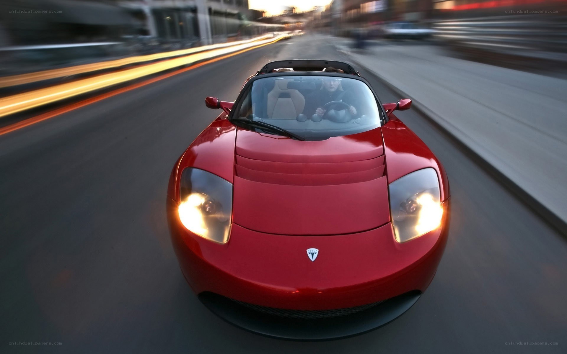 Red Tesla Roadster in motion