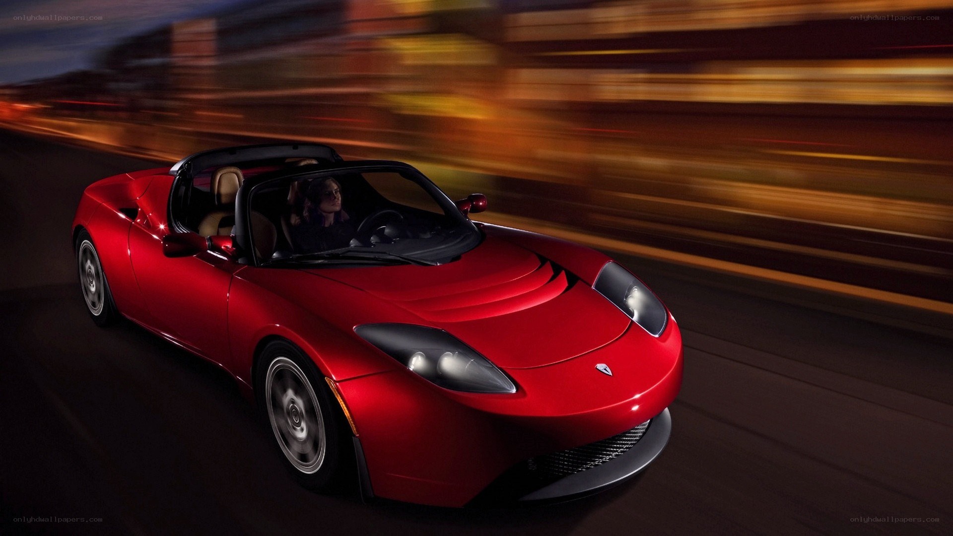 Red Tesla Roadster in motion