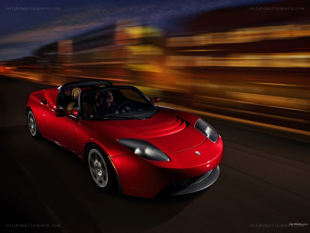 Red Tesla Roadster in motion