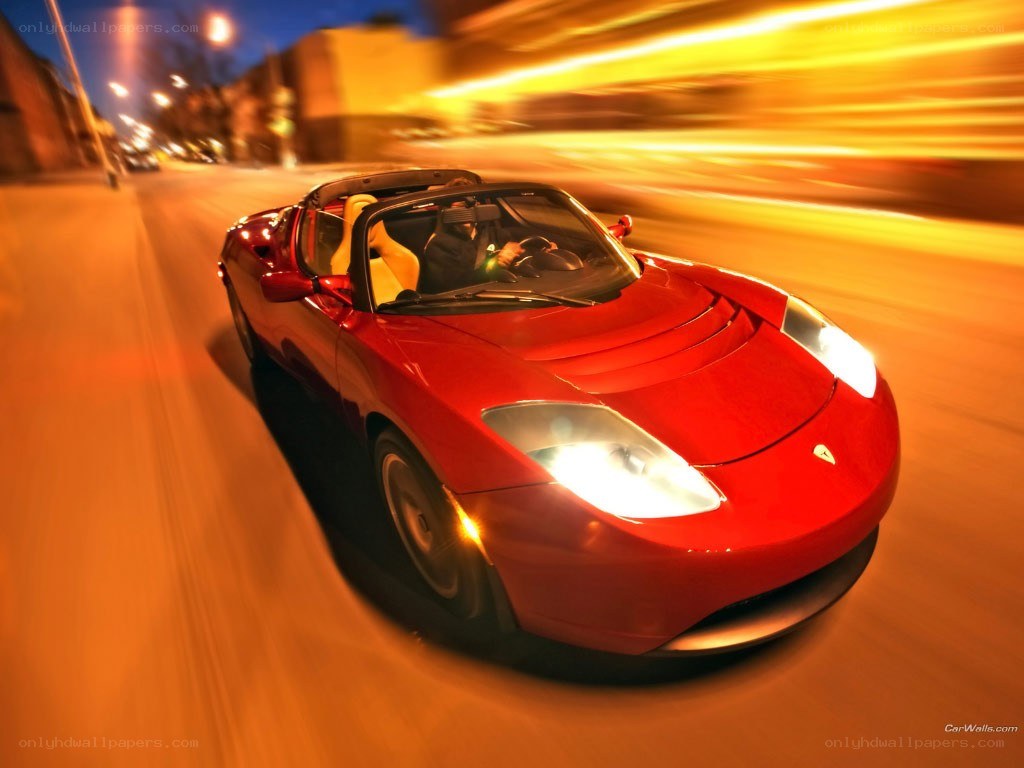 Red Tesla Roadster in motion