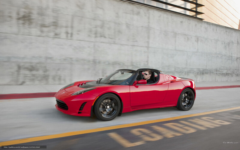 Red Tesla Roadster in motion