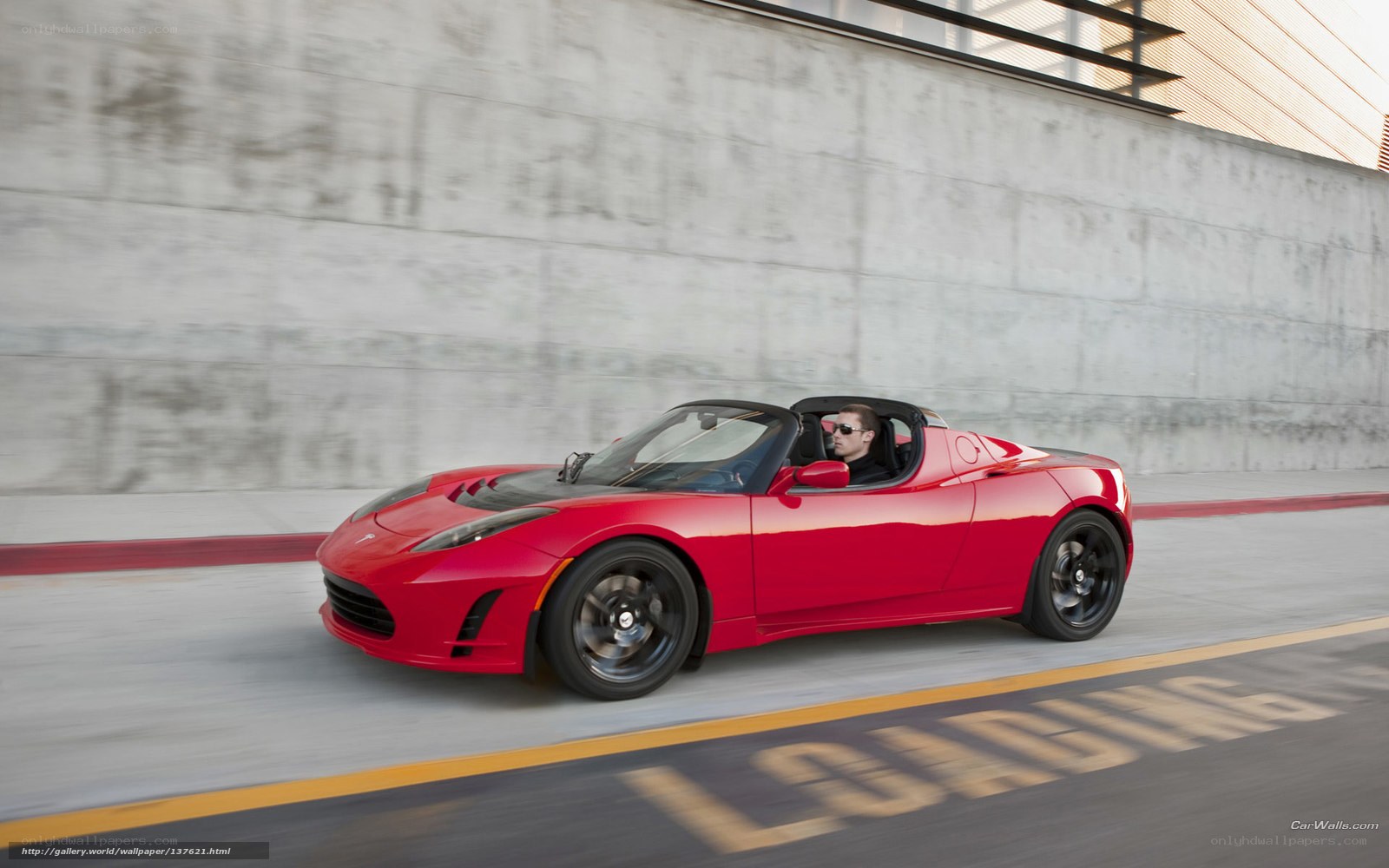 Red Tesla Roadster in motion