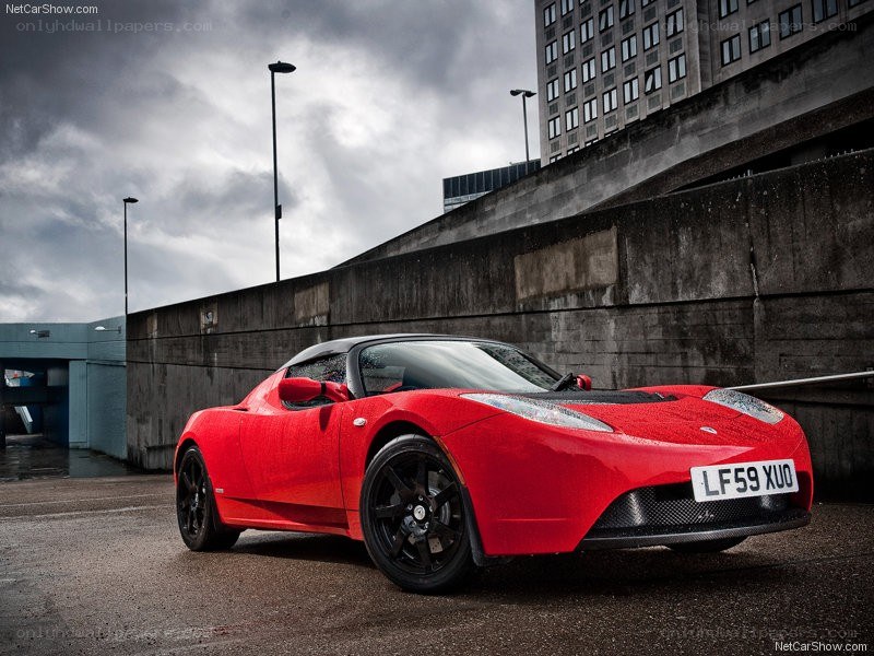 Red Tesla Roadster in urban setting