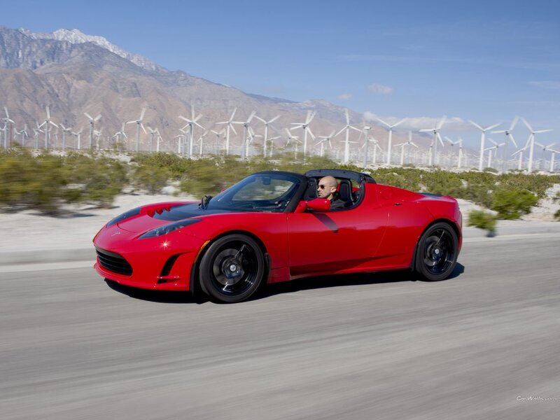 Red Tesla Roadster on desert road