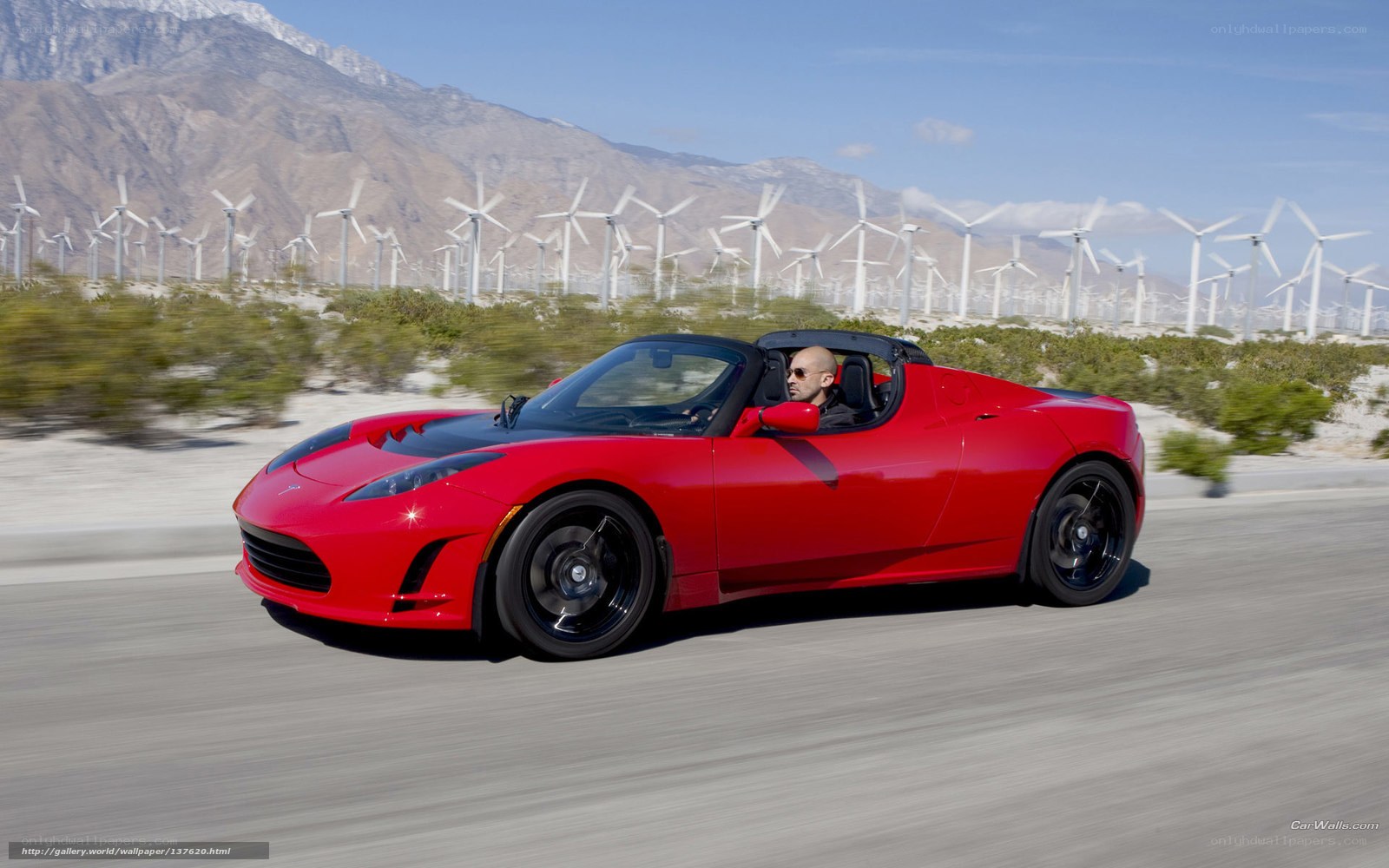 Red Tesla Roadster on desert road