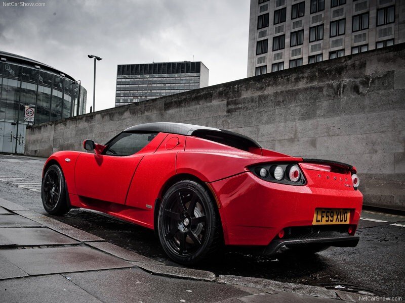 Red Tesla Roadster parked on street