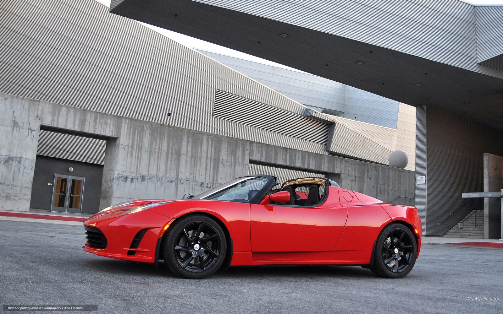 Red Tesla Roadster parked