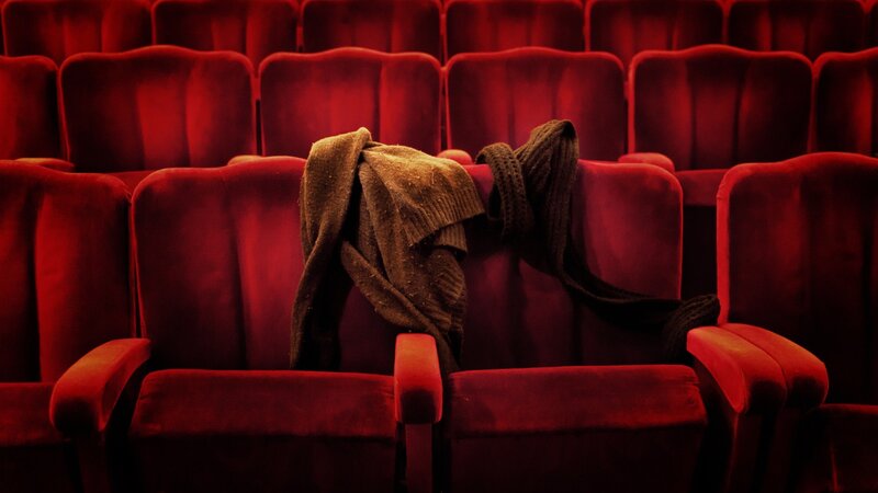 Red theater seats with sweater