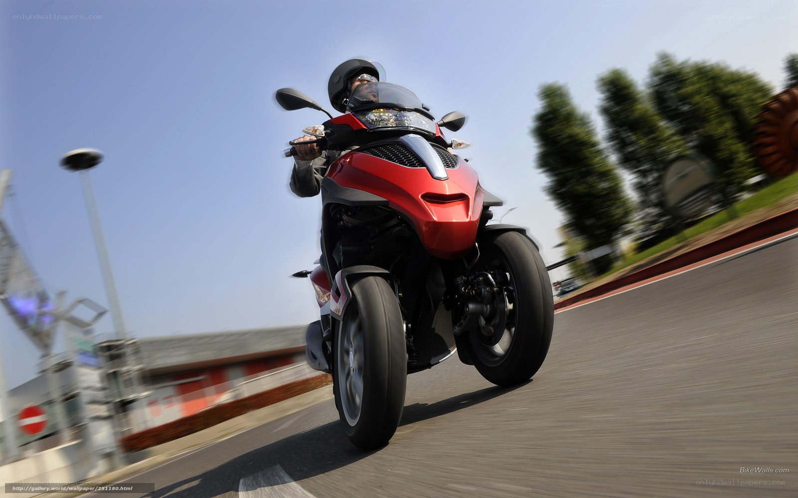 Red three-wheeled motorcycle in motion
