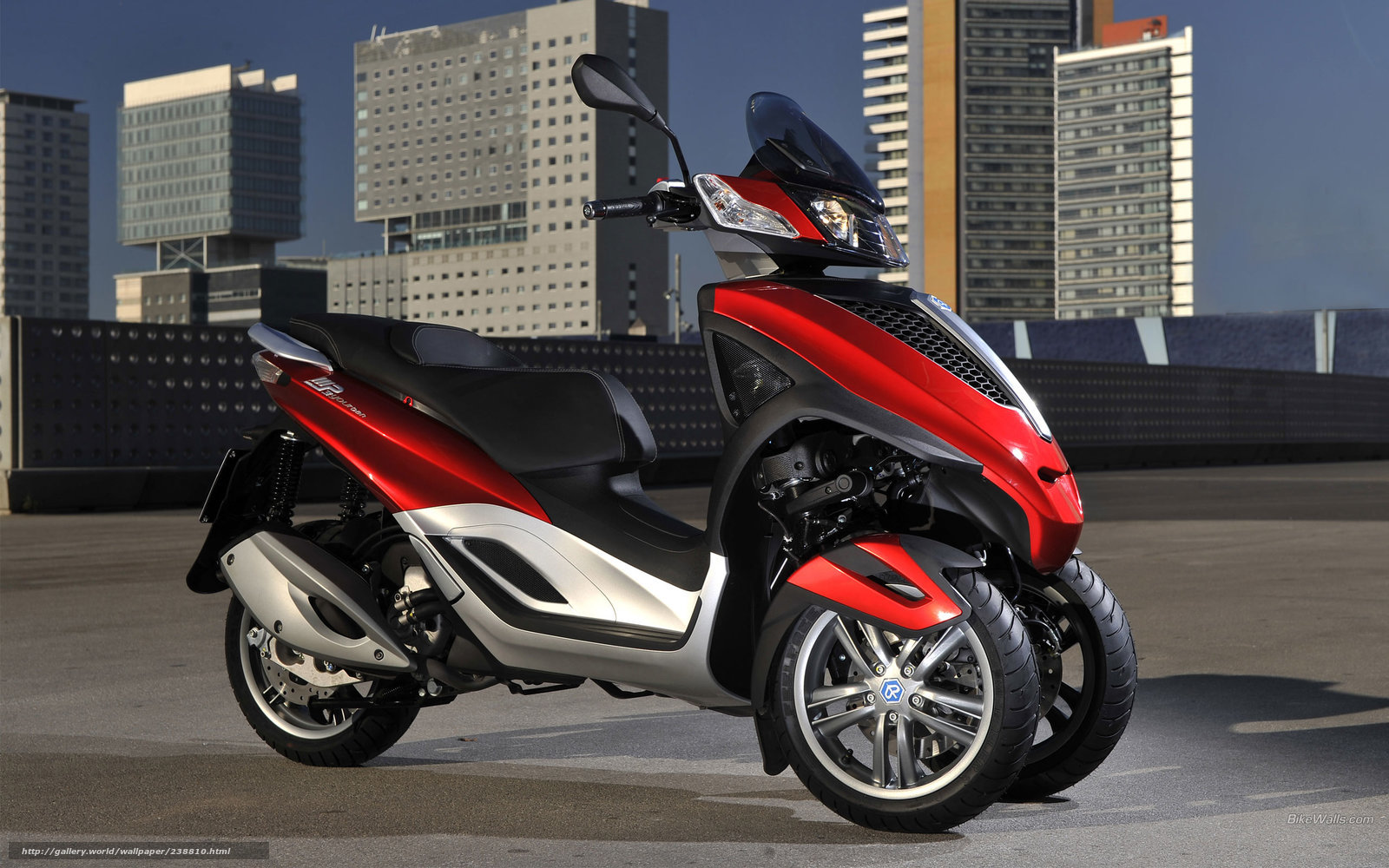 Red three-wheeled scooter in city