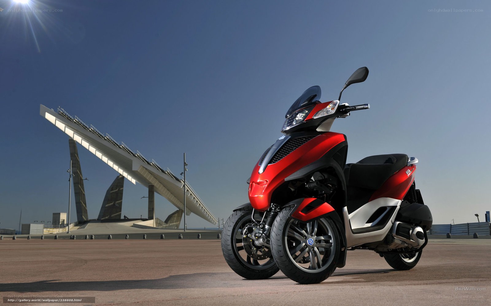 Red three-wheeled scooter on display