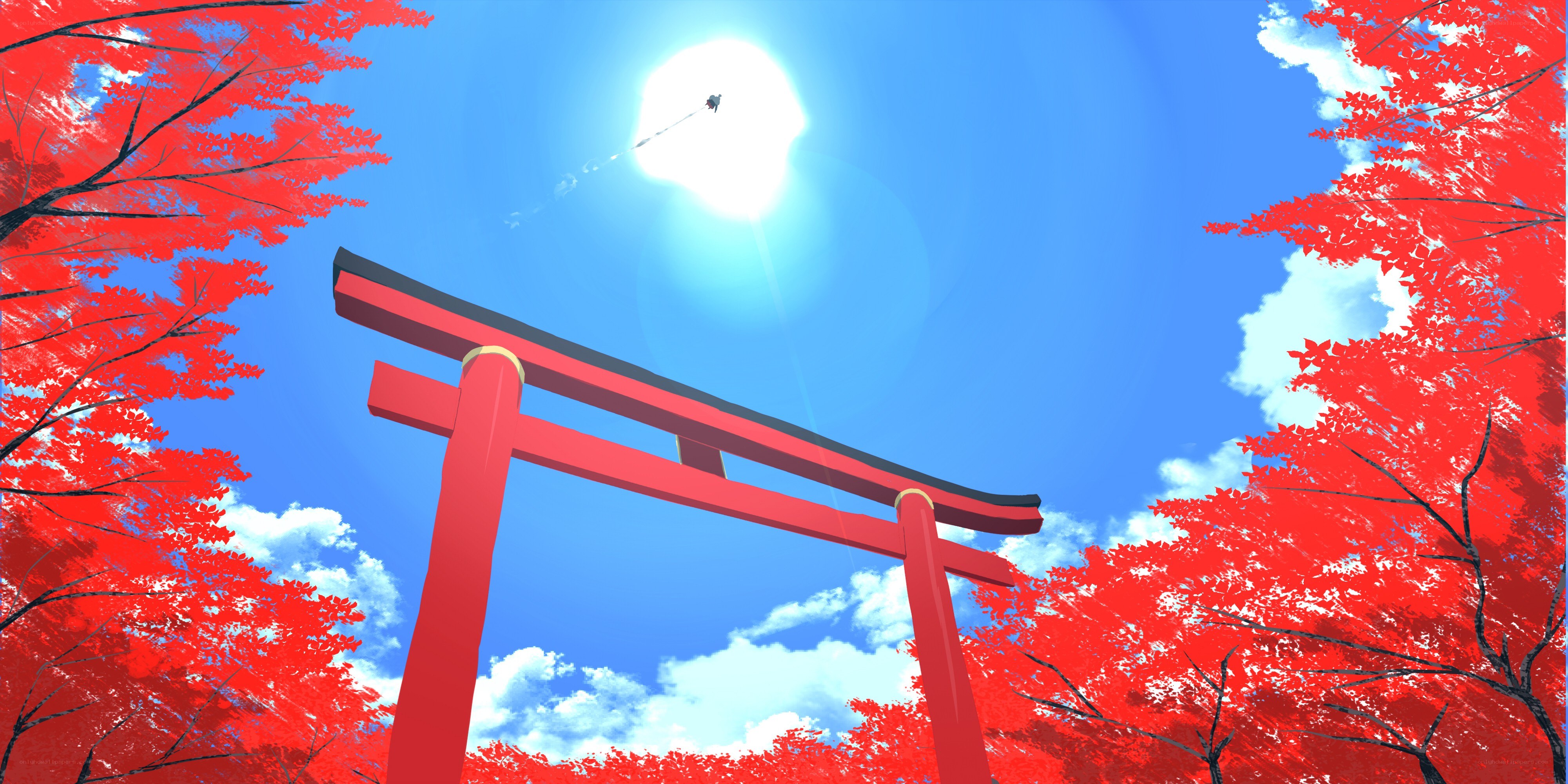 Red torii gate under blue sky