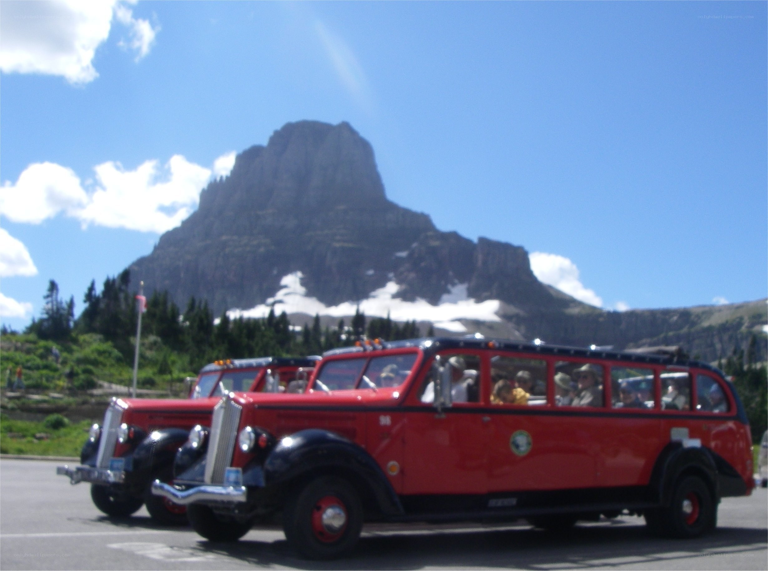 Red tour buses at mountain peak