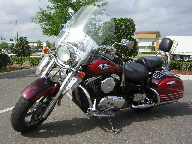 Red touring motorcycle in parking lot