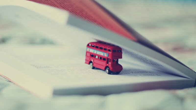 Red Toy Bus on Book — Calm, Photograph