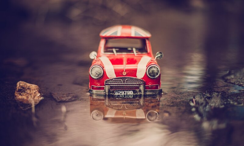 Red Toy Car in Water — Dramatic
