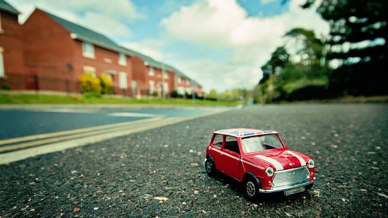 Red toy car on a street