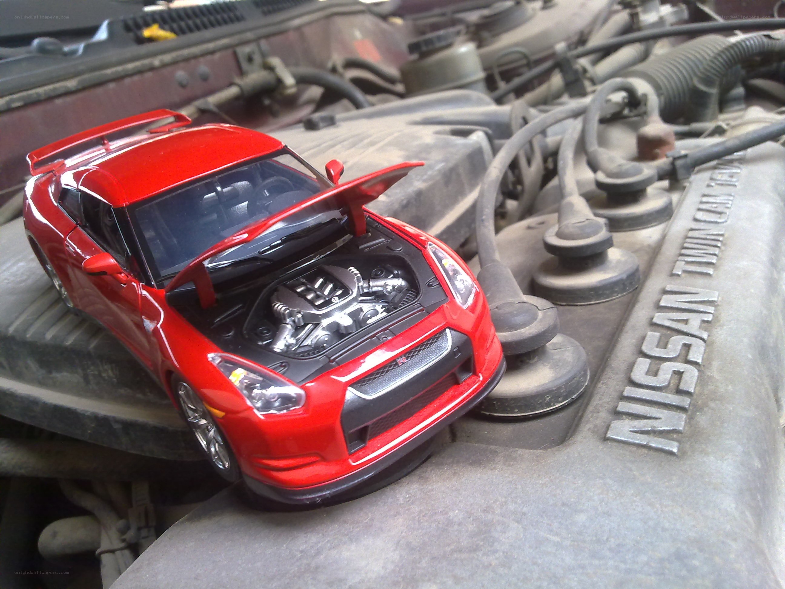 Red toy car on engine