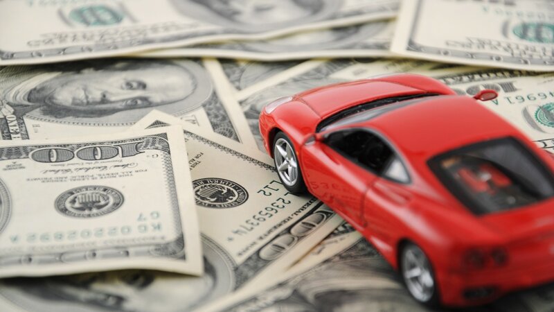 Red Toy Car on Money