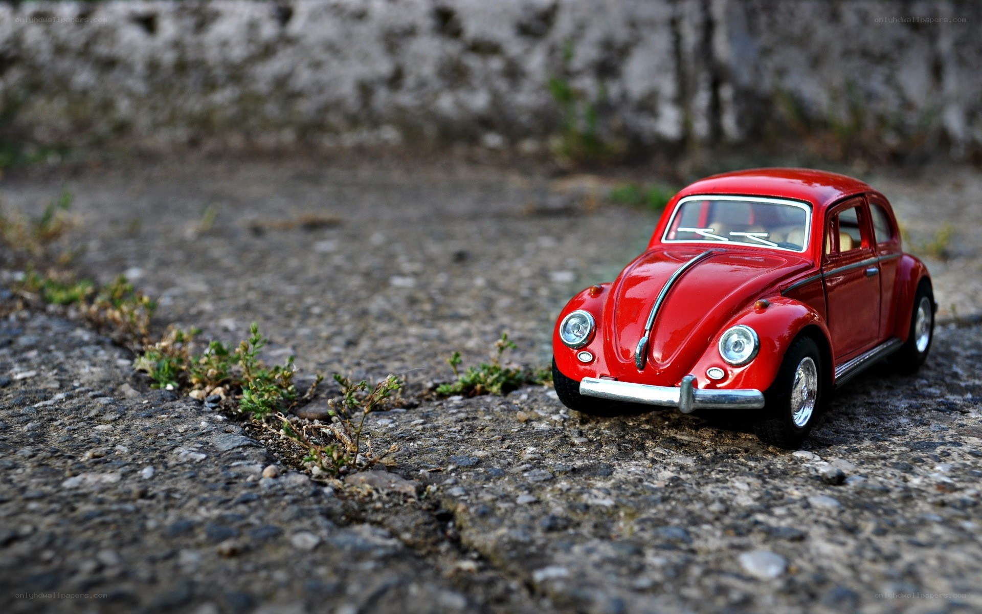 Red toy car on pavement