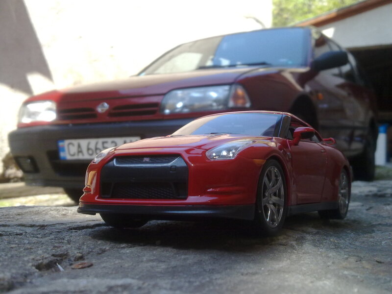 Red toy car on pavement