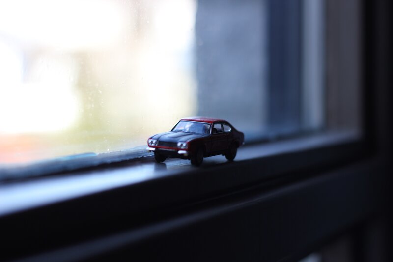 Red Toy Car on Windowsill
