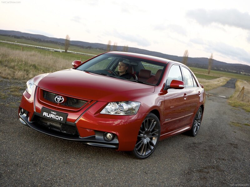 Red Toyota Aurion on a rural road