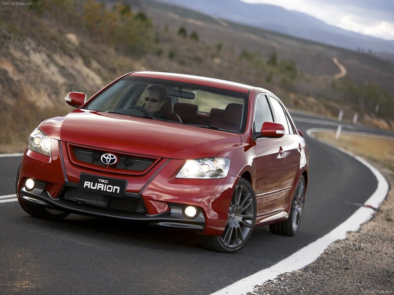 Red Toyota Aurion on winding road