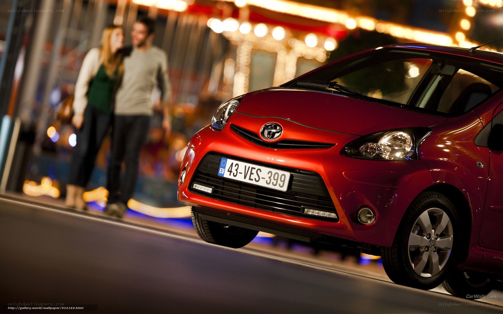 Red Toyota Aygo at night