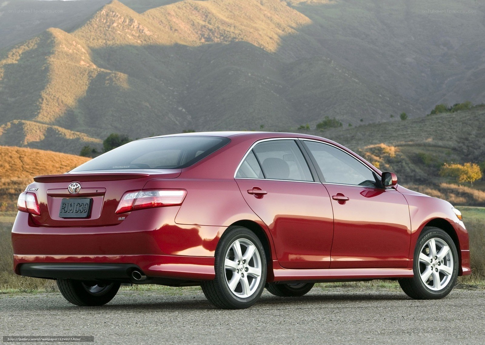 Red Toyota Camry in mountain setting