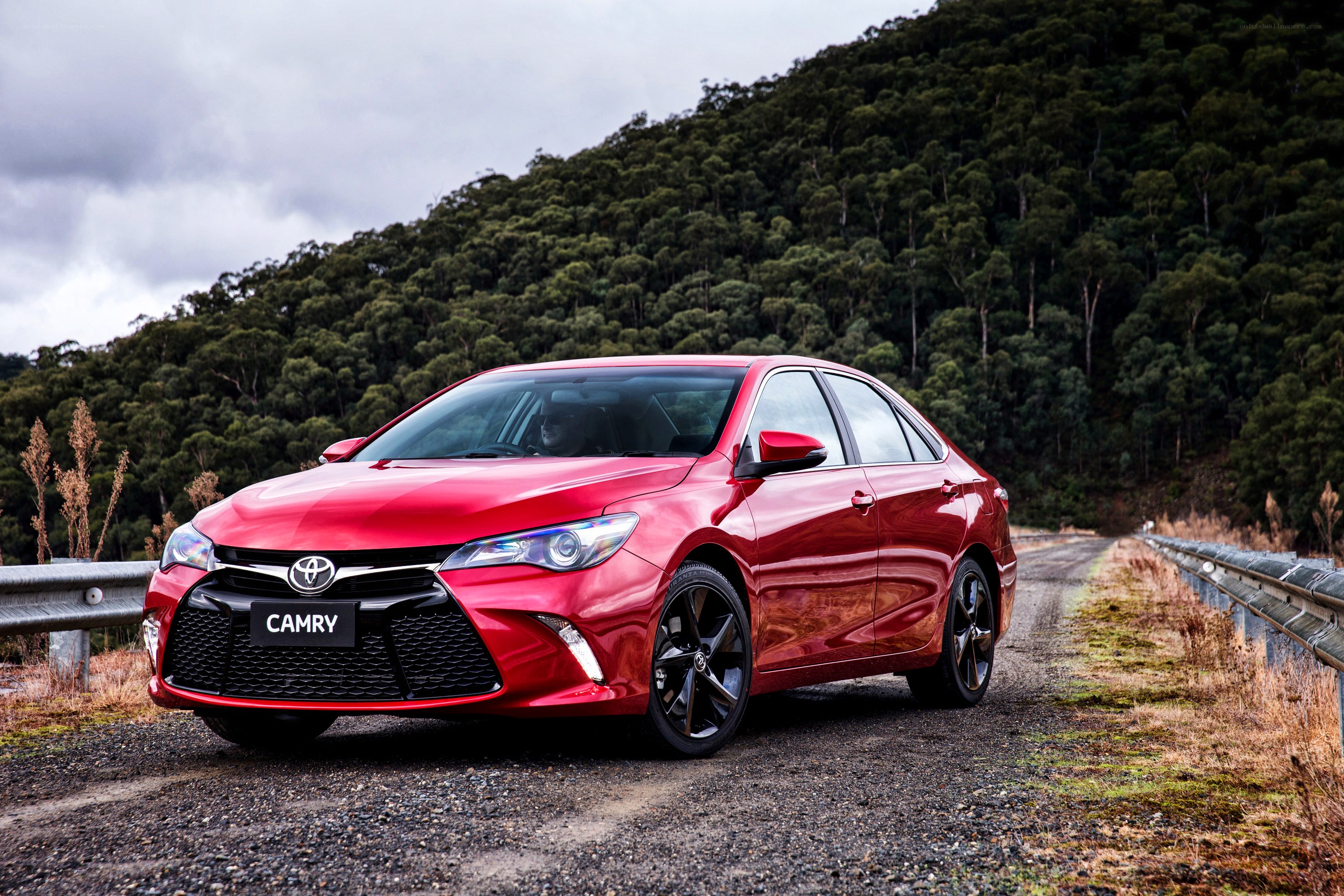 Red Toyota Camry on a road