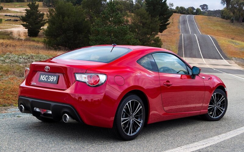 Red Toyota GT86 on a winding road