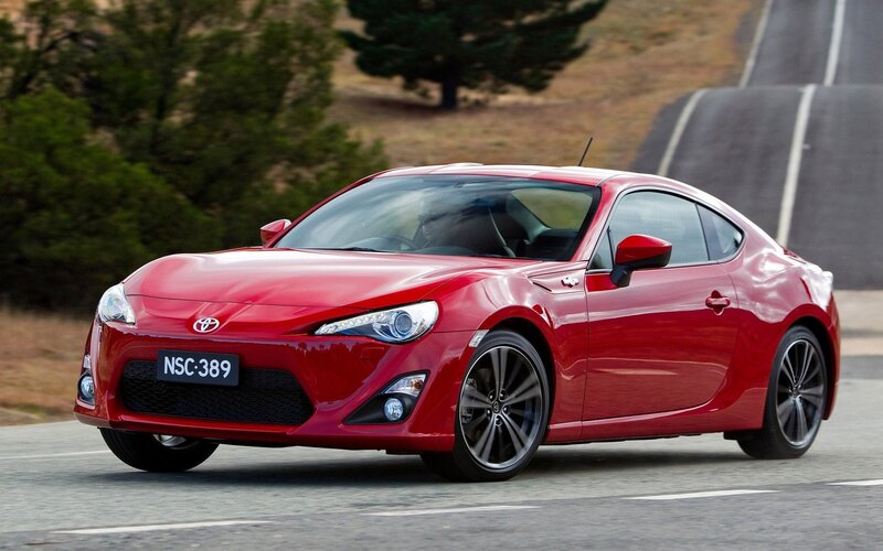 Red Toyota GT86 on a winding road