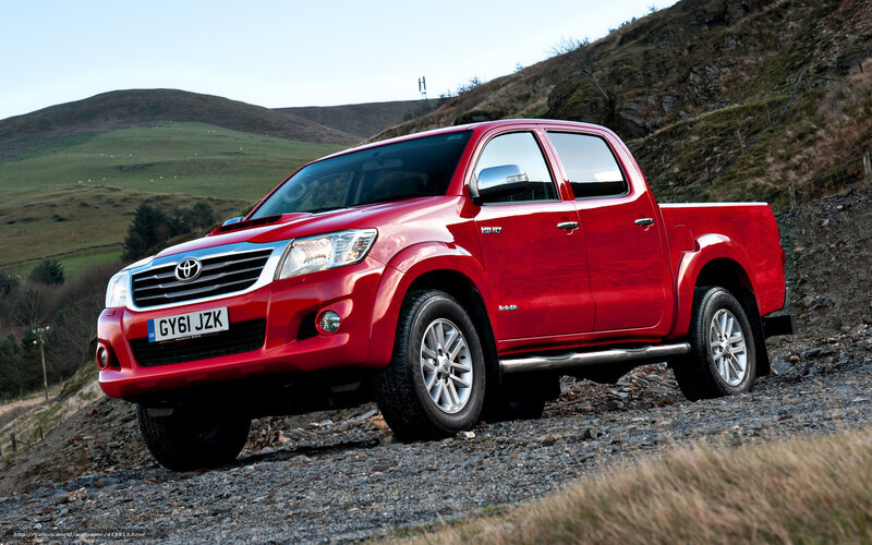 Red Toyota Hilux on gravel