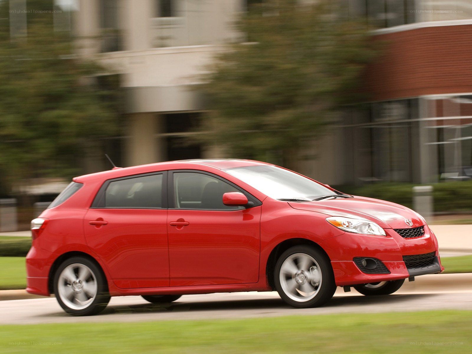 Red Toyota Matrix in motion