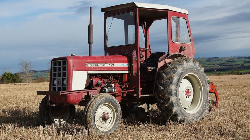 Red Tractor in Field — Calm, Afternoon, Photograph