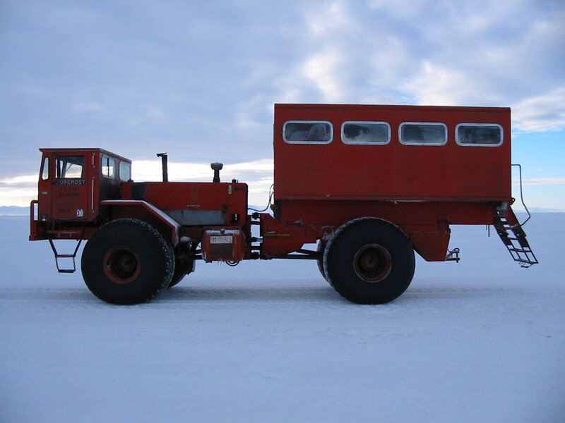 Red tractor on snowy plain