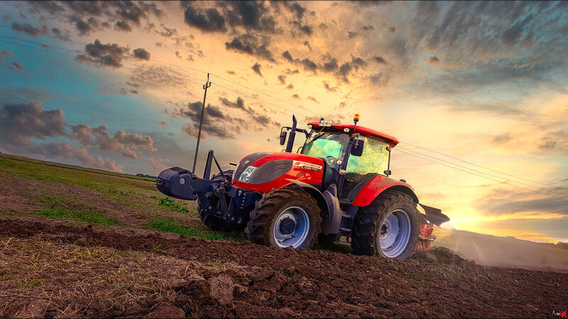 Red Tractor Plowing Field — Dramatic