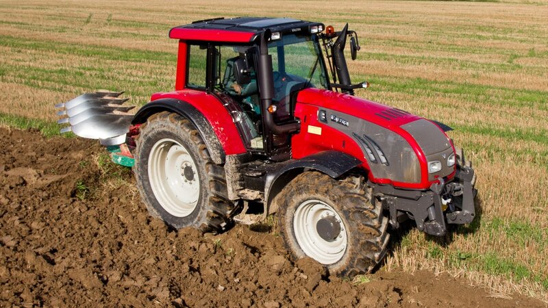Red Tractor Plowing Field