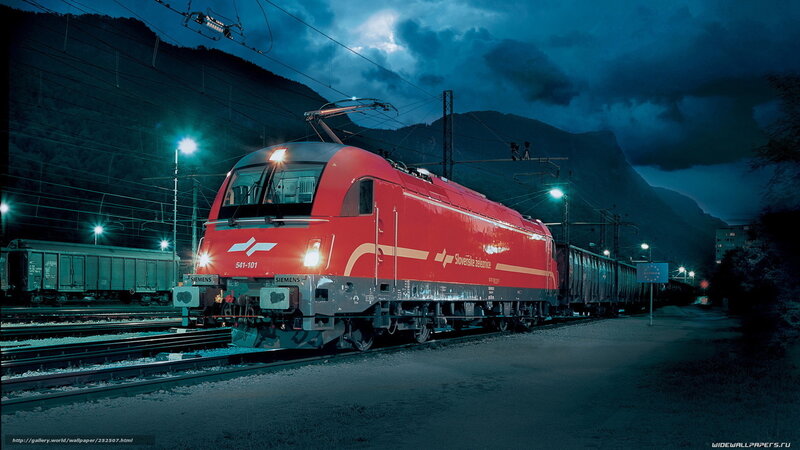 Red train at night in mountains