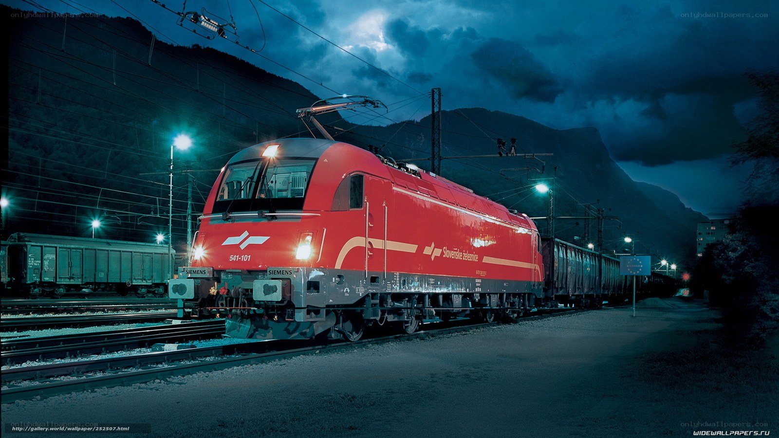 Red train at night in mountains