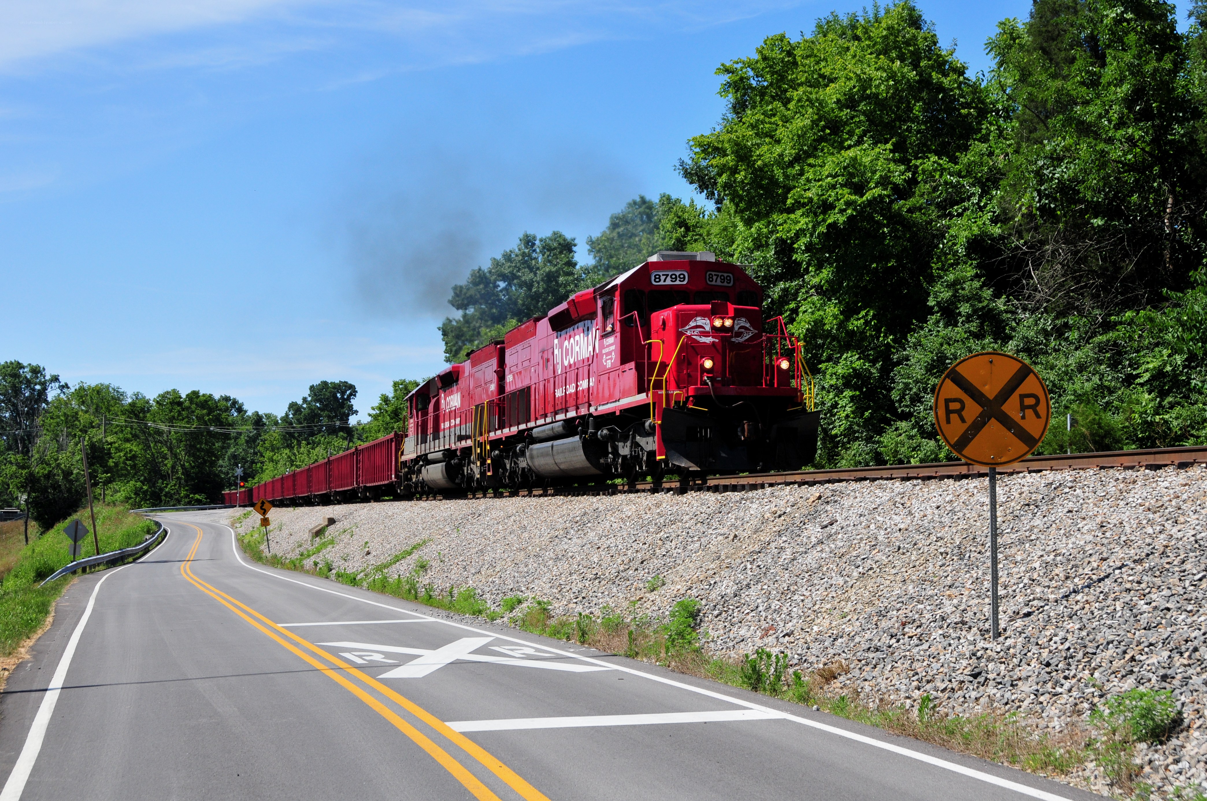 Red train at railroad crossing