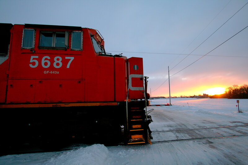 Red train at sunset in snow