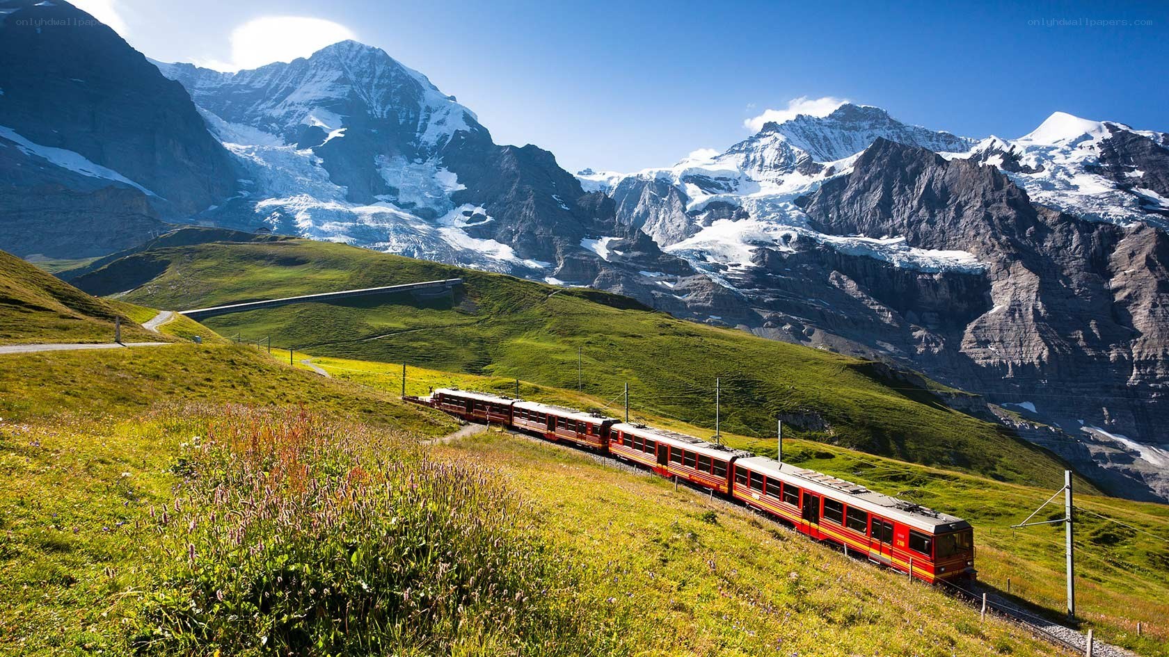 Red train in alpine landscape