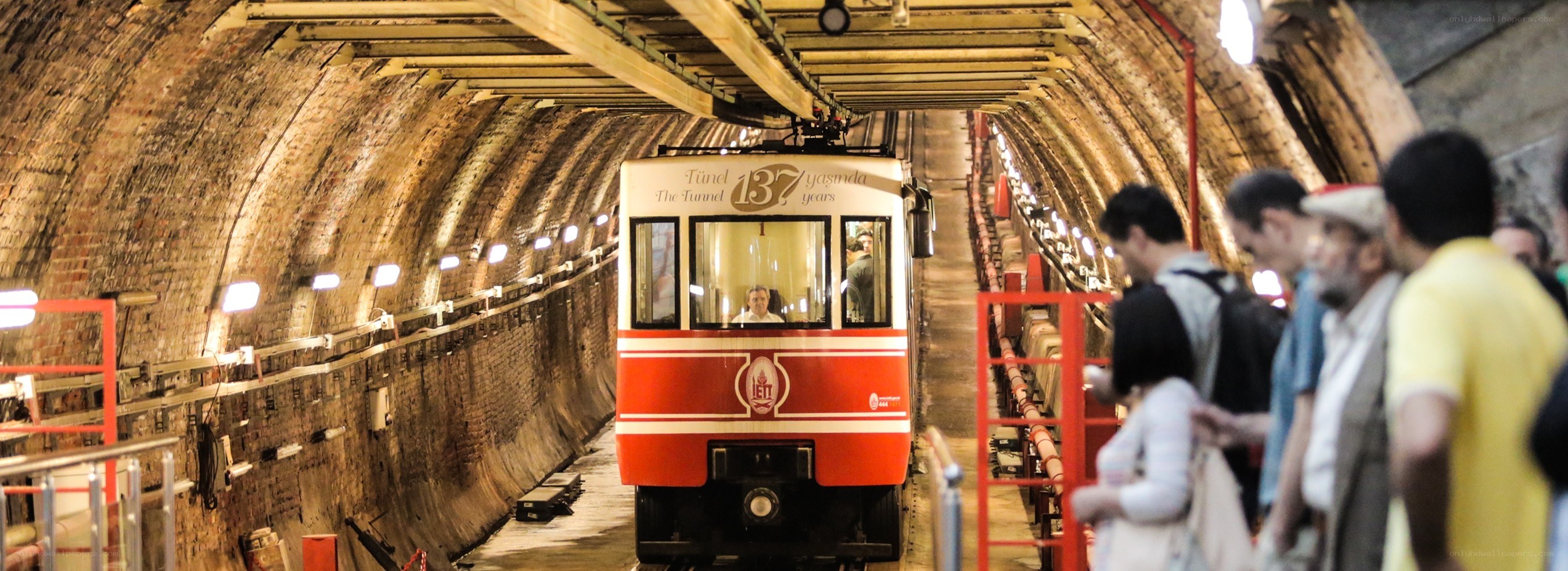Red train in historic tunnel